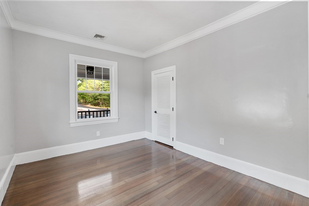 187 Indian Lane Canton, MA 02021 - Photo 14 of 26 an empty room with wooden floor and windows