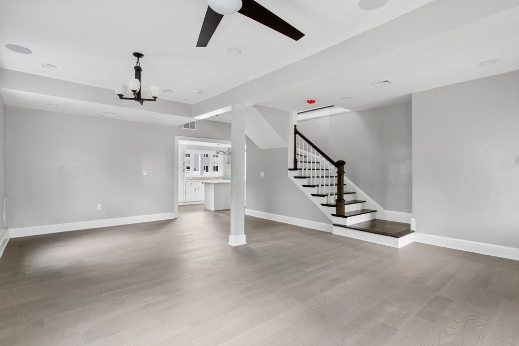 187 Indian Lane Canton, MA 02021 - Photo 17 of 26 an empty room with staircase and windows