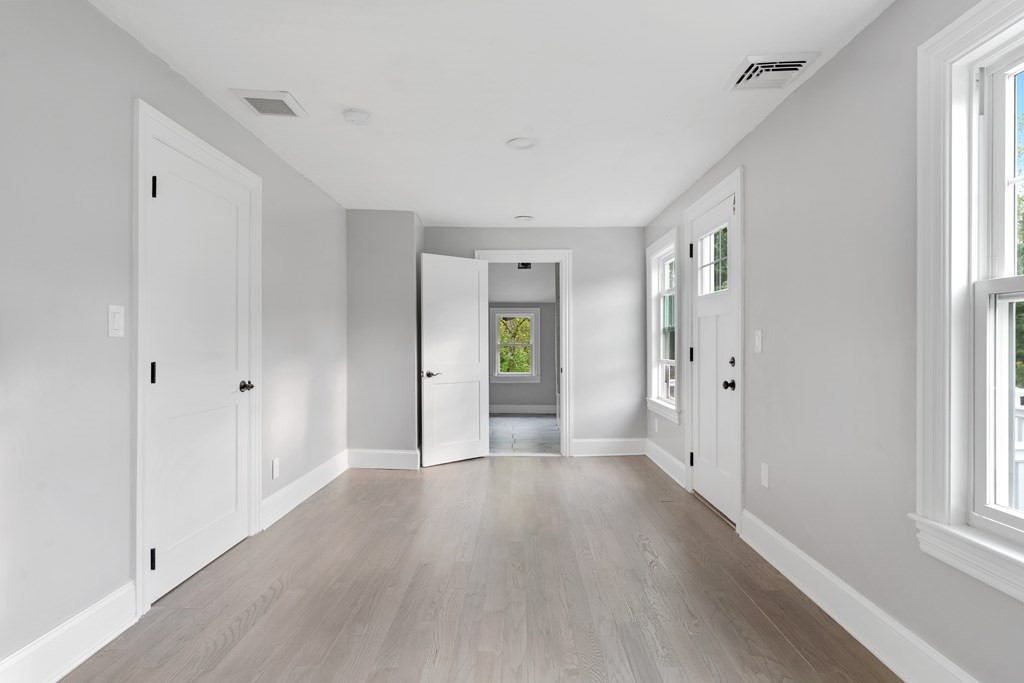 187 Indian Lane Canton, MA 02021 - Photo 22 of 26 a view of an empty room with wooden floor and a window
