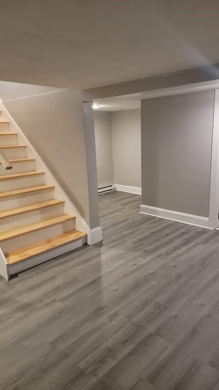 187 Indian Lane Canton, MA 02021 - Photo 26 of 26 a view of an empty room with wooden floor and stairs