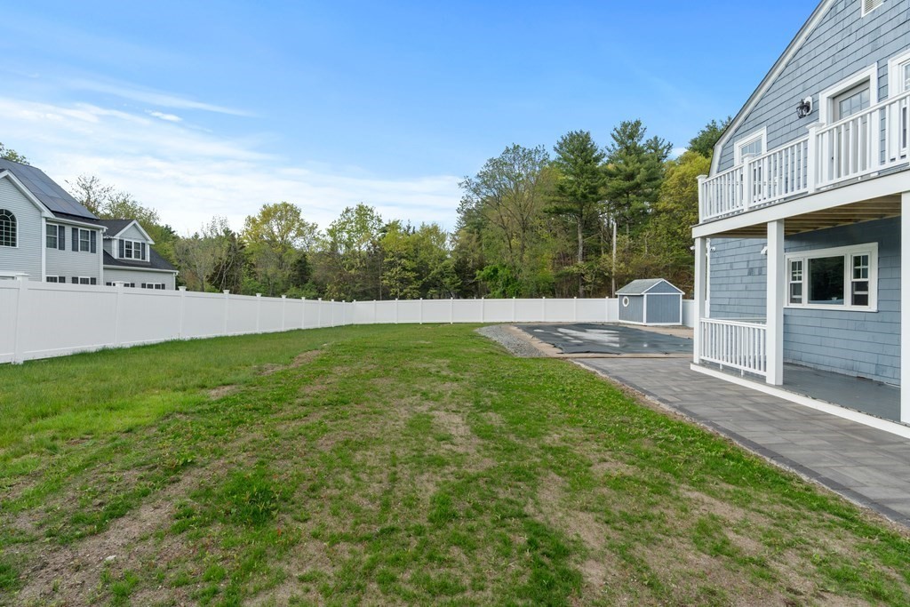 187 Indian Lane Canton, MA 02021 - Photo 5 of 26 a view of yard with swimming pool and trees in the background