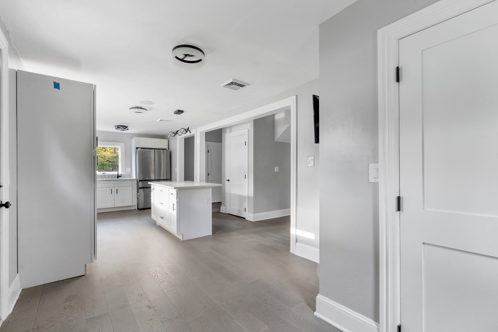 187 Indian Lane Canton, MA 02021 - Photo 6 of 26 a view of a kitchen with living room and windows