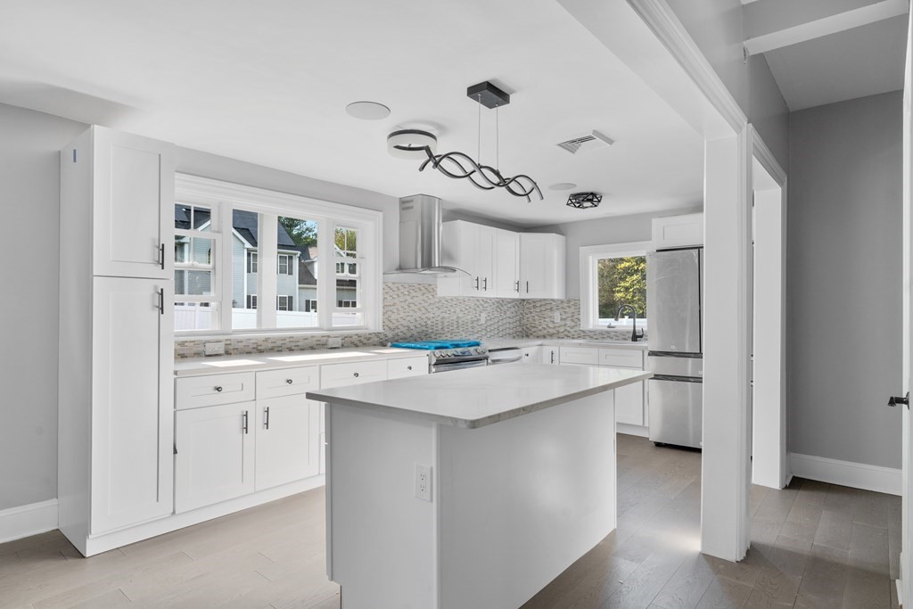 187 Indian Lane Canton, MA 02021 - Photo 8 of 26 a kitchen with a sink stove and cabinets