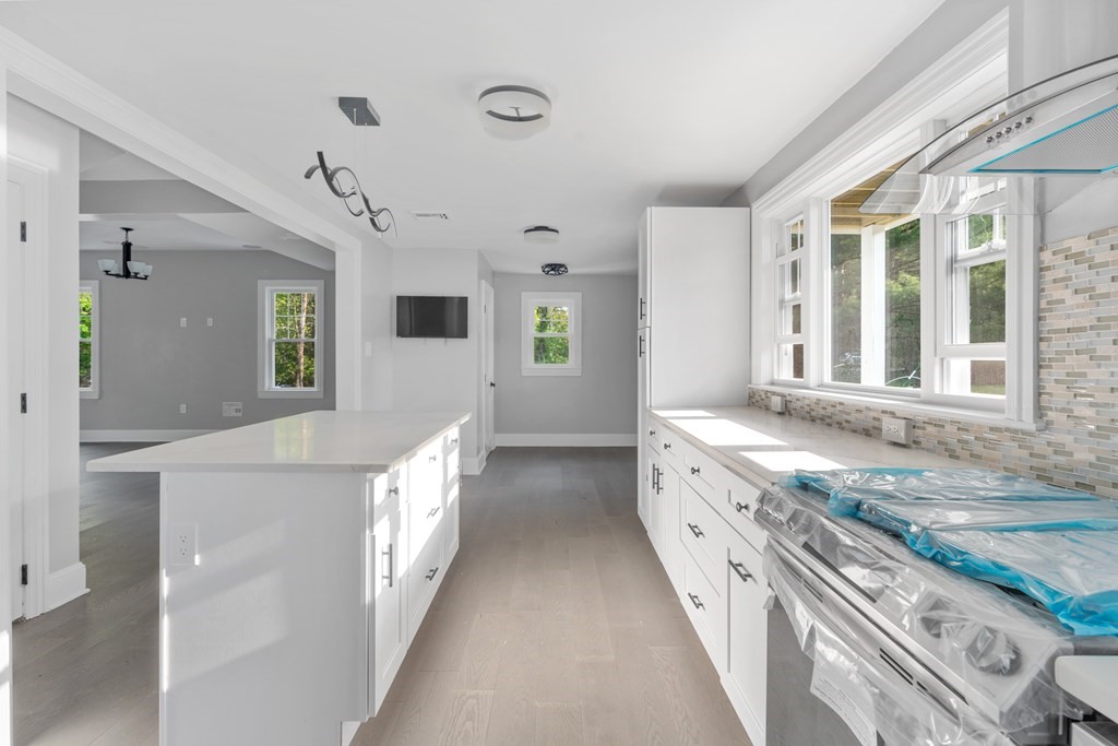 187 Indian Lane Canton, MA 02021 - Photo 9 of 26 a bathroom with a sink and a large mirror