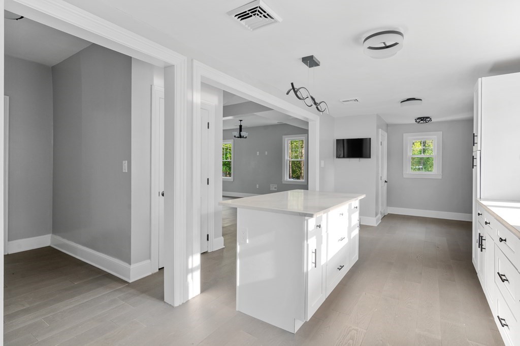 187 Indian Lane Canton, MA 02021 - Photo 10 of 26 a large kitchen with a lot of counter space and wooden floor