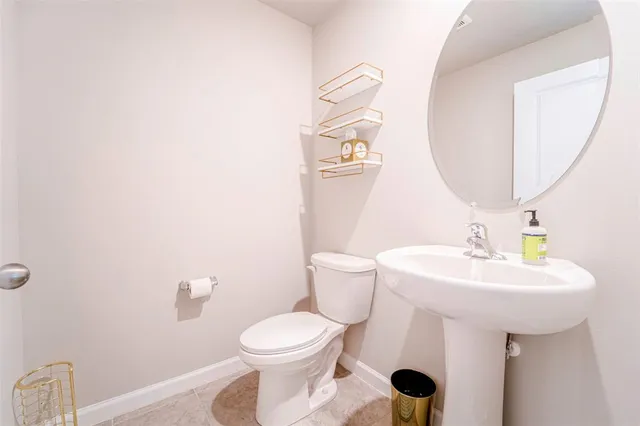 a white toilet sitting next to a bathroom sink