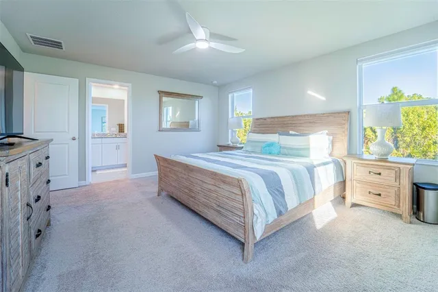 a spacious bedroom with a bed and a dresser
