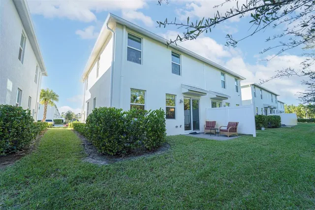 a front view of house with yard and outdoor seating