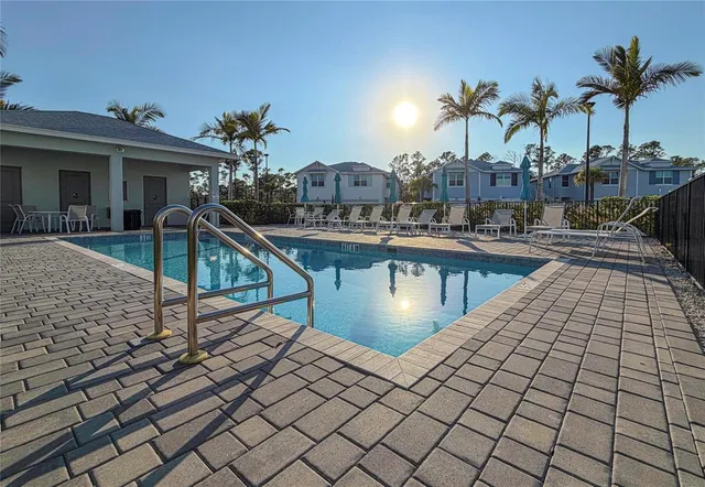 a view of a swimming pool with chairs
