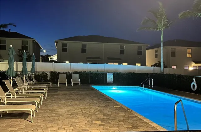 a view of a swimming pool with chairs