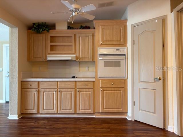 1894 Elizabeth Lane Mount Dora, FL 32757 - Photo 20 of 69 a kitchen with stainless steel appliances granite countertop a refrigerator and a stove top oven