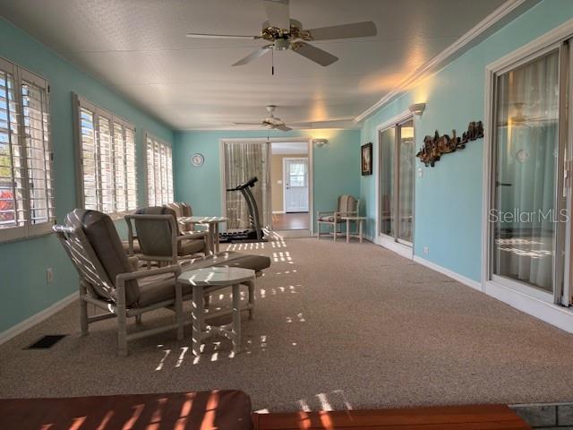 1894 Elizabeth Lane Mount Dora, FL 32757 - Photo 38 of 69 a living room with furniture a large window and a chandelier