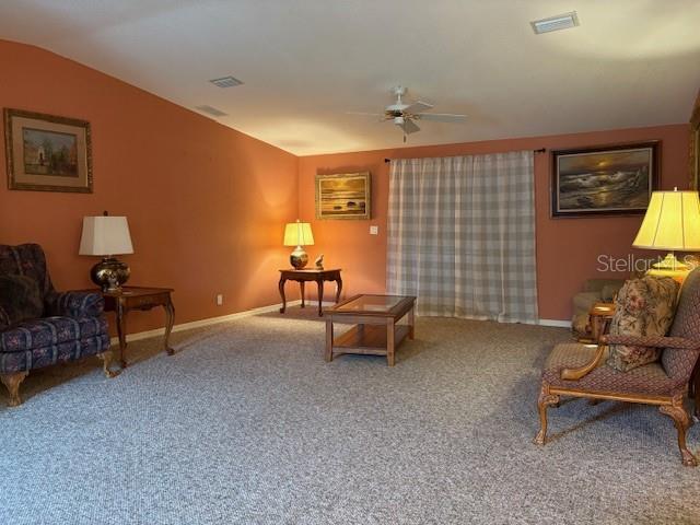 1894 Elizabeth Lane Mount Dora, FL 32757 - Photo 4 of 69 a living room with furniture and a lamp