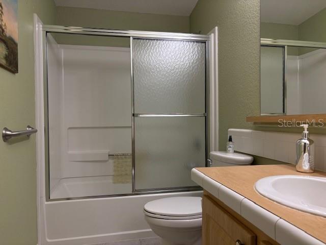 1894 Elizabeth Lane Mount Dora, FL 32757 - Photo 46 of 69 a bathroom with a granite countertop toilet sink and shower