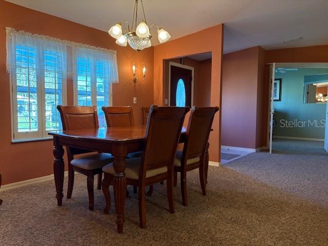 1894 Elizabeth Lane Mount Dora, FL 32757 - Photo 7 of 69 a dining room with furniture a chandelier and a rug