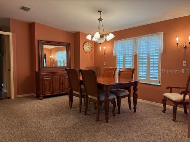 1894 Elizabeth Lane Mount Dora, FL 32757 - Photo 8 of 69 a view of a dining room with furniture and chandelier