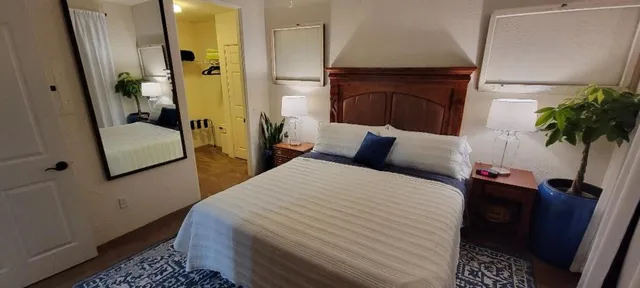 a bed sitting in a bedroom next to a window