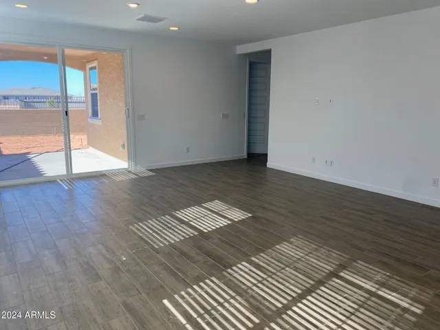 a view of wooden floor and windows in a room