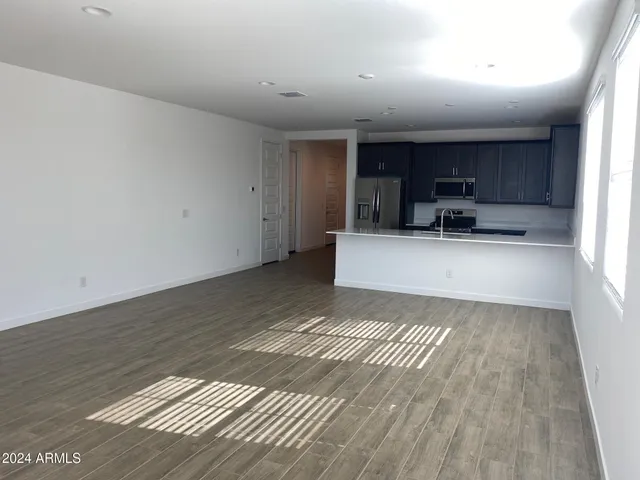 a view of a kitchen with a sink and dishwasher wooden floor