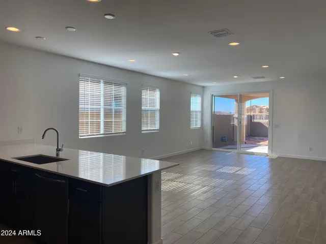 a kitchen with granite countertop a sink and cabinets