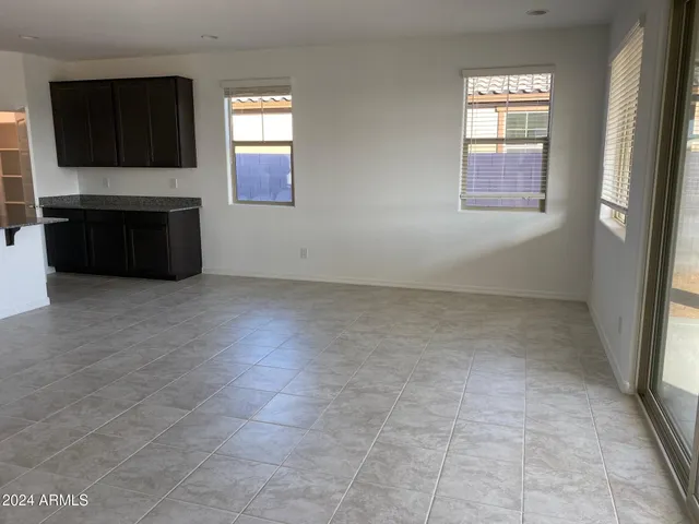 a view of an empty room with window and fireplace