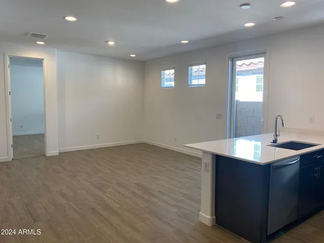 a kitchen with sink and mirror