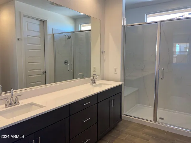 a bathroom with a granite countertop sink mirror and double