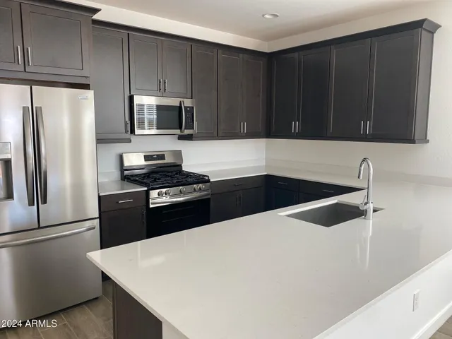 a kitchen with a refrigerator and a sink