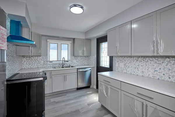 a kitchen with a sink stove and cabinets