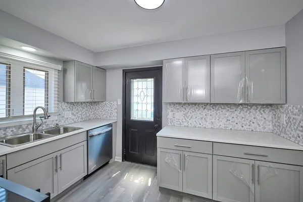 a kitchen with a sink and cabinets