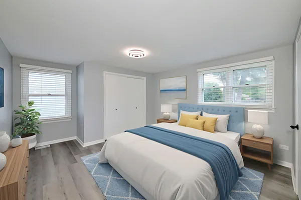 a bedroom with a large bed and potted plant