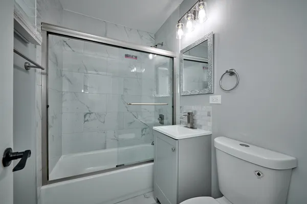 a bathroom with a sink toilet and shower