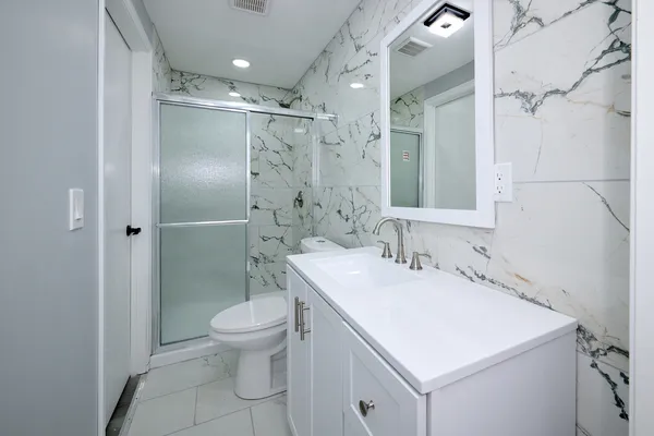 a bathroom with a sink toilet and shower