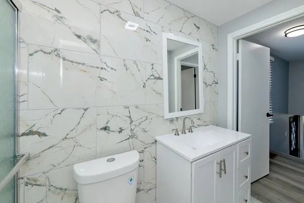 a bathroom with a sink toilet and shower