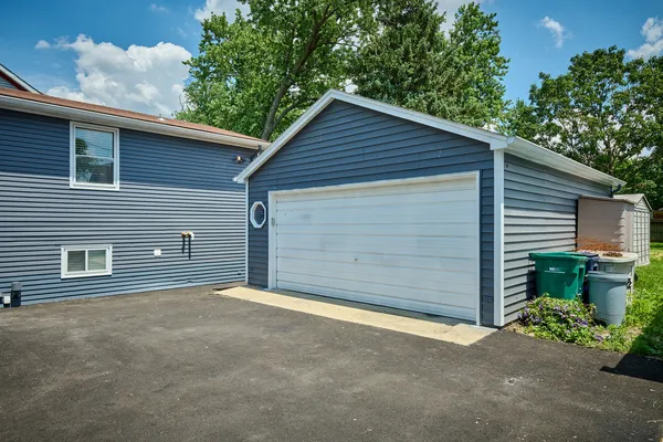 a view of a house with garage and yard