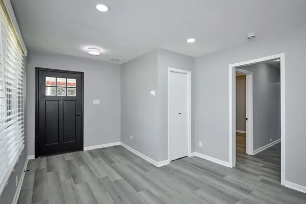 an empty room with closet and wooden floor