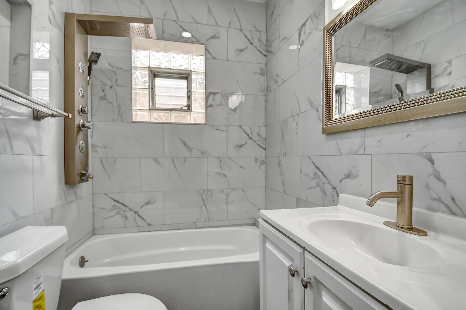 7409 West 63rd Place Summit, IL 60501 - Photo 11 of 18 a bathroom with a sink a toilet and shower