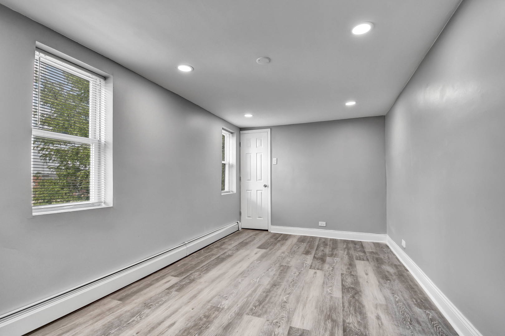 7409 West 63rd Place Summit, IL 60501 - Photo 14 of 18 an empty room with wooden floor and windows