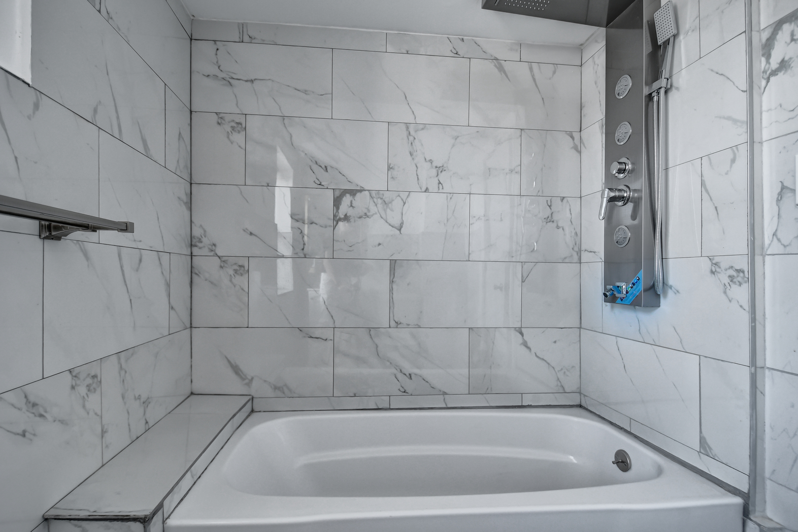 7409 West 63rd Place Summit, IL 60501 - Photo 16 of 18 a bathroom with a bath tub and shower