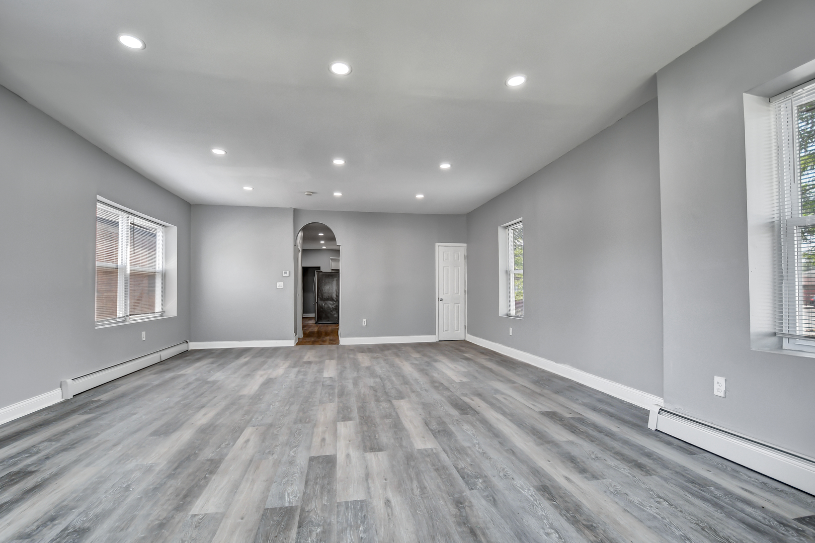 7409 West 63rd Place Summit, IL 60501 - Photo 3 of 18 an empty room with wooden floor and windows