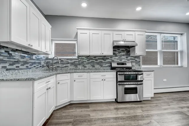 a kitchen with stainless steel appliances granite countertop a stove and a sink