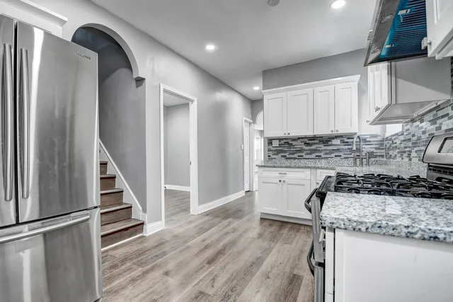 a kitchen with a sink a stove and cabinets