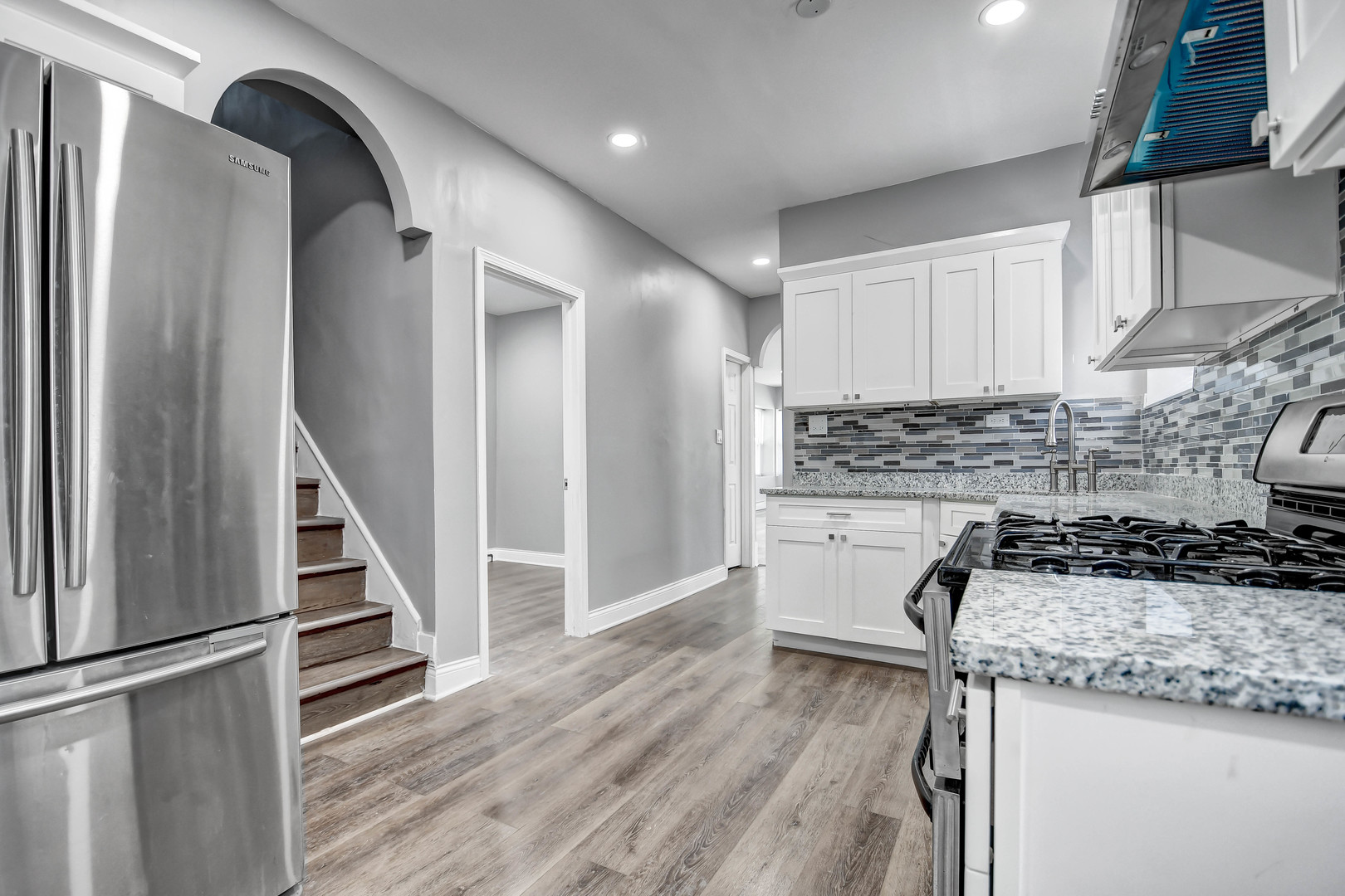 7409 West 63rd Place Summit, IL 60501 - Photo 7 of 18 a kitchen with a sink a stove and cabinets