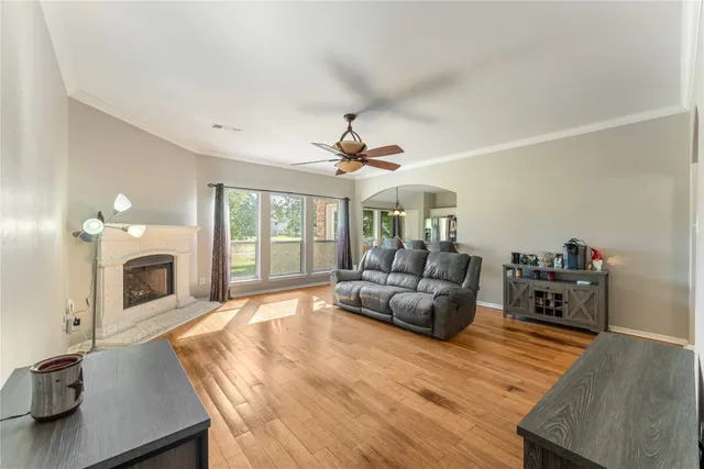 a living room with furniture large window and a fireplace