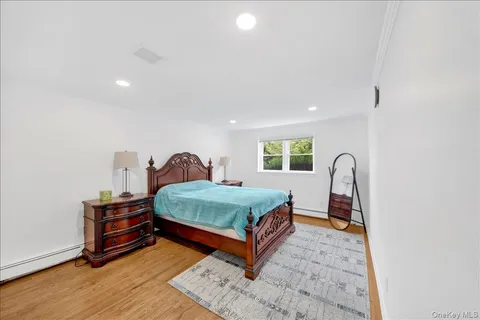 a bedroom with a bed window and dresser