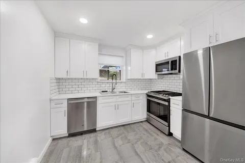 a kitchen with a refrigerator stove and microwave
