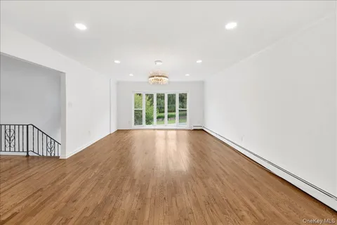 a view of an empty room and wooden floor