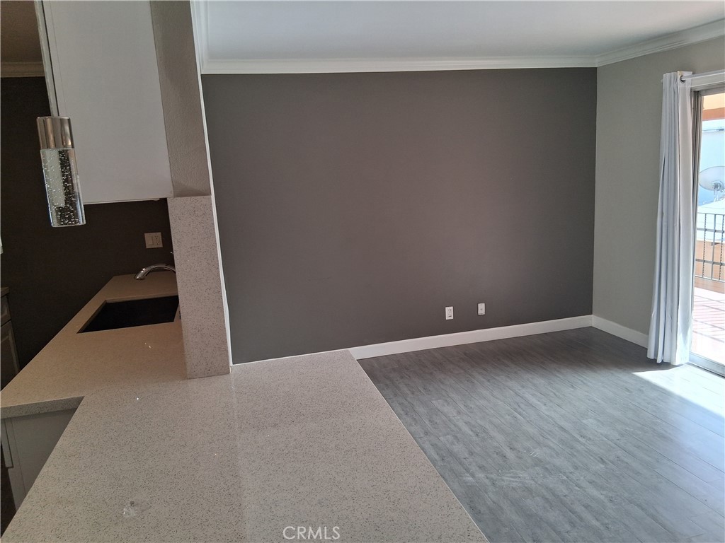 1040 Cedar Avenue, Unit 6 Long Beach, CA 90813 - Photo 4 of 17 an empty room with wooden floor and windows