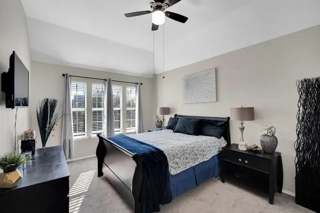 a living room with furniture a flat screen tv and a large window