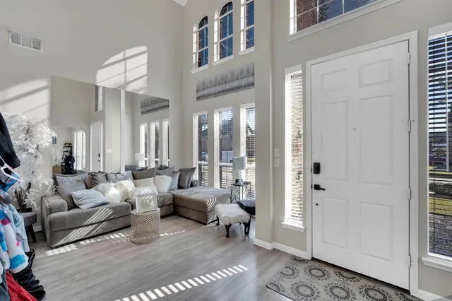 a living room with furniture wooden floor and a rug